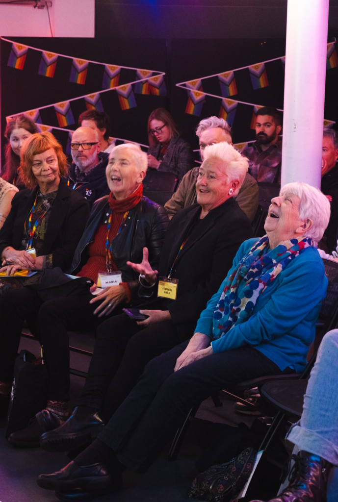 Audience of older women laughing at The Coast Is Queer, including Jane Traies