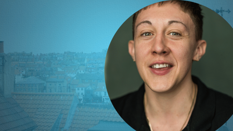 Charlie Josephine, writing from lived experience. A photo of Charlie on a blue roofscape.