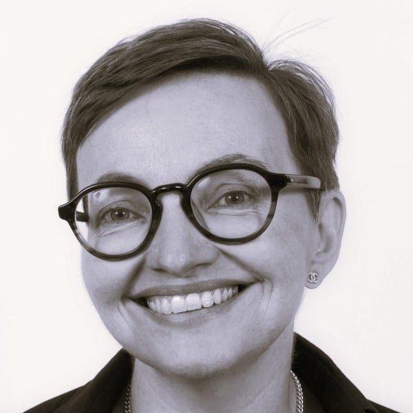 Clare Lydon Image description: a white woman with short dark hair and glasses