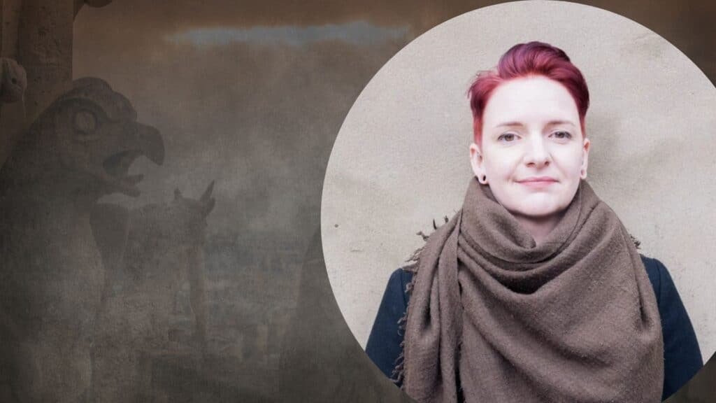 Heather Parry, a yougn white woman with short ginger hair, in a circle with a dark gothic gargoyle background