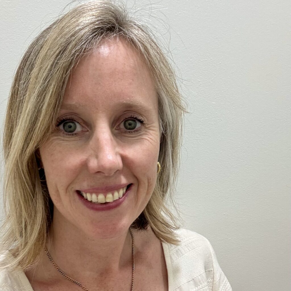 Lucy Howkins, a middle-aged white woman with blonde hair and a white top. No background.