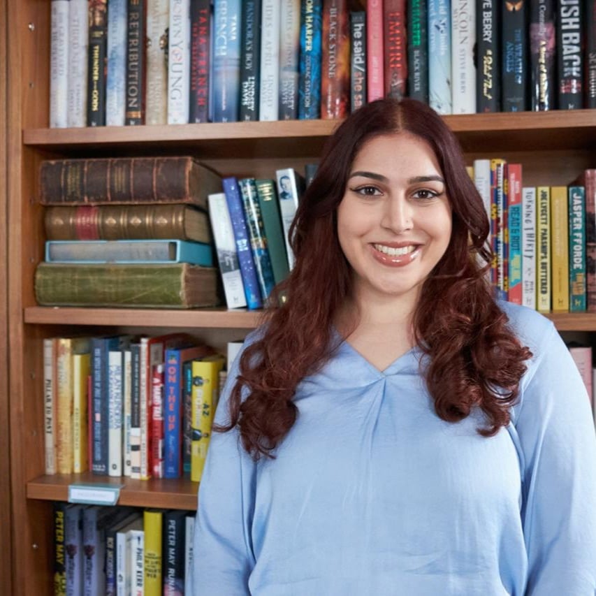 Raiyah Butt, a young Arabic woman with long brown hair and a blue top